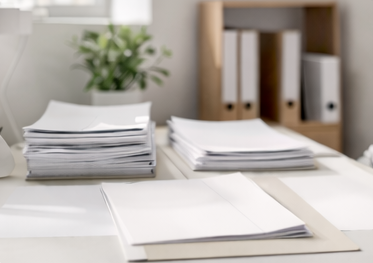 clean organised desk with structured documents and soft natural lighting, minimal clinical environment, muted tones